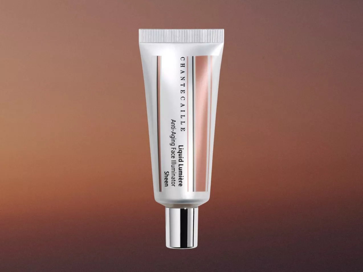 Chantecaille Liquid Lumiere anti-ageing face illuminator tube on warm brown background, skincare product shot