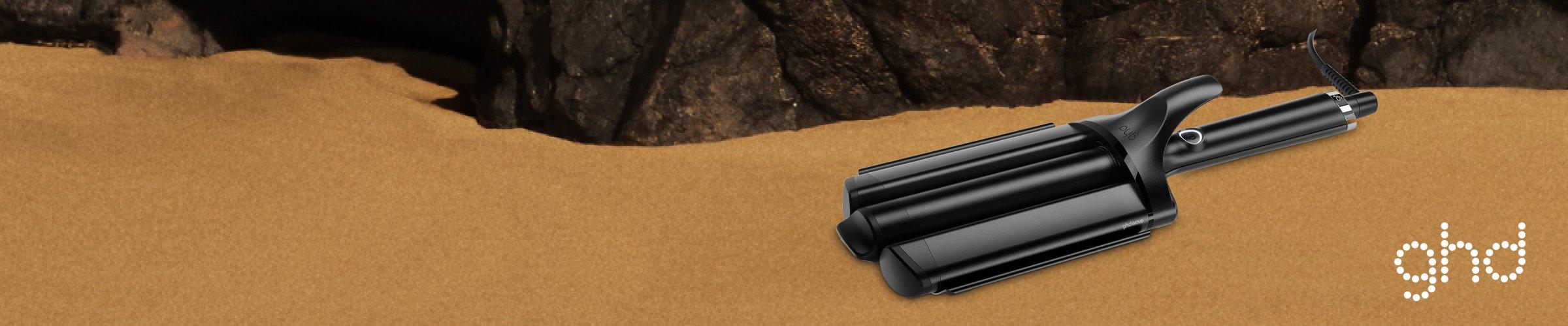 Image of GHDs sitting on some sand