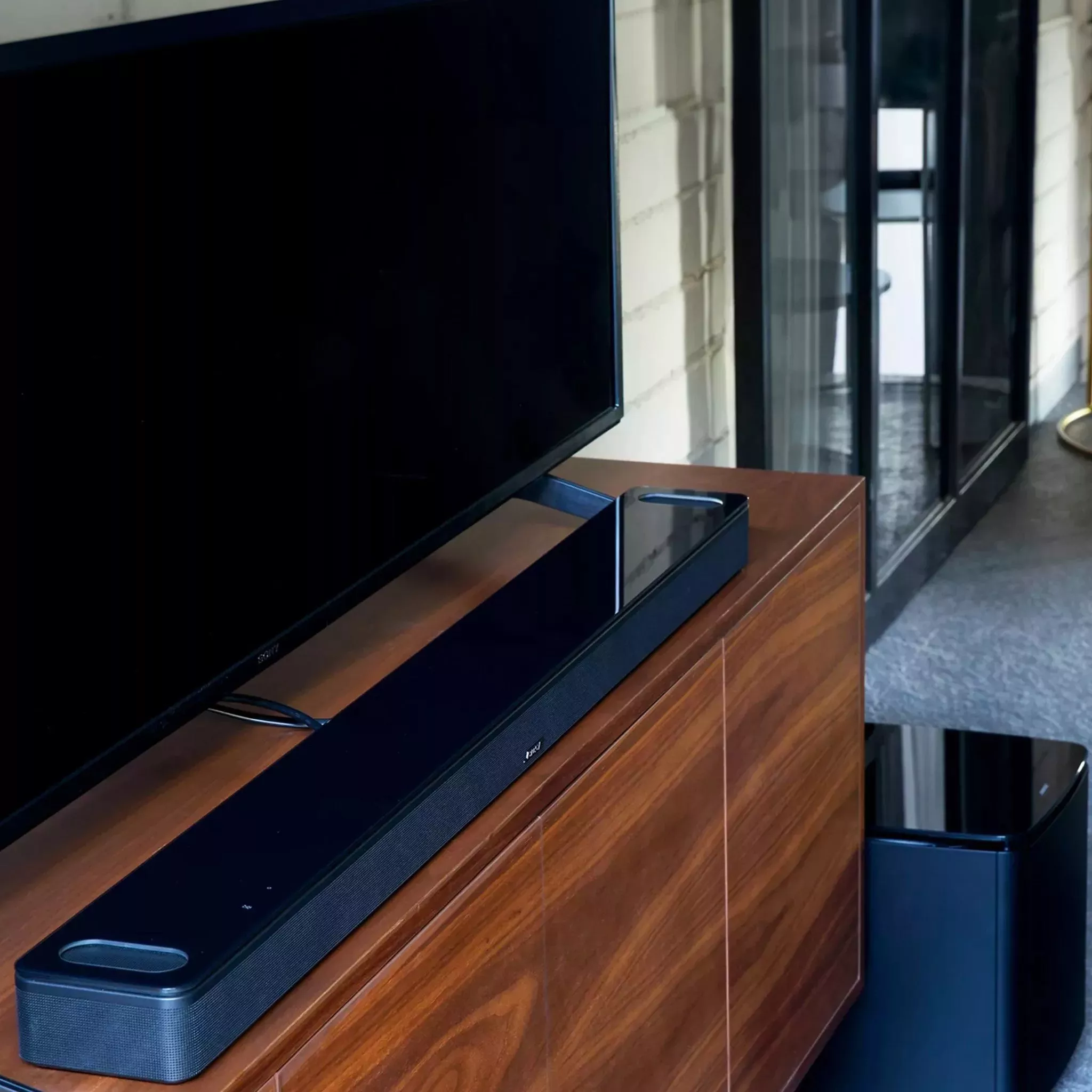 Soundbar and TV on a wooden TV stand 