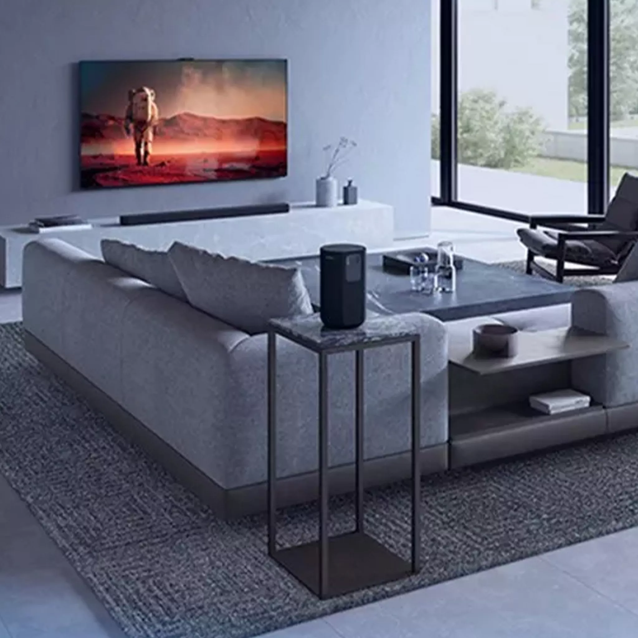 Black soundbar on a sideboard under a wall mount TV in a living room setting 