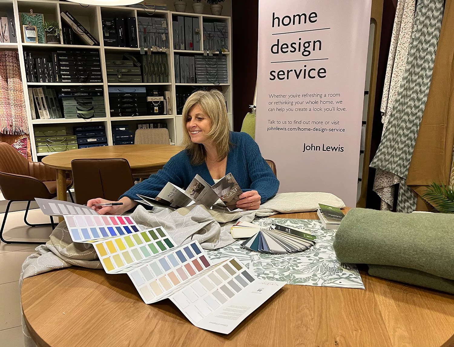 woman looking at colour swatches in a john lewis home design service appointment