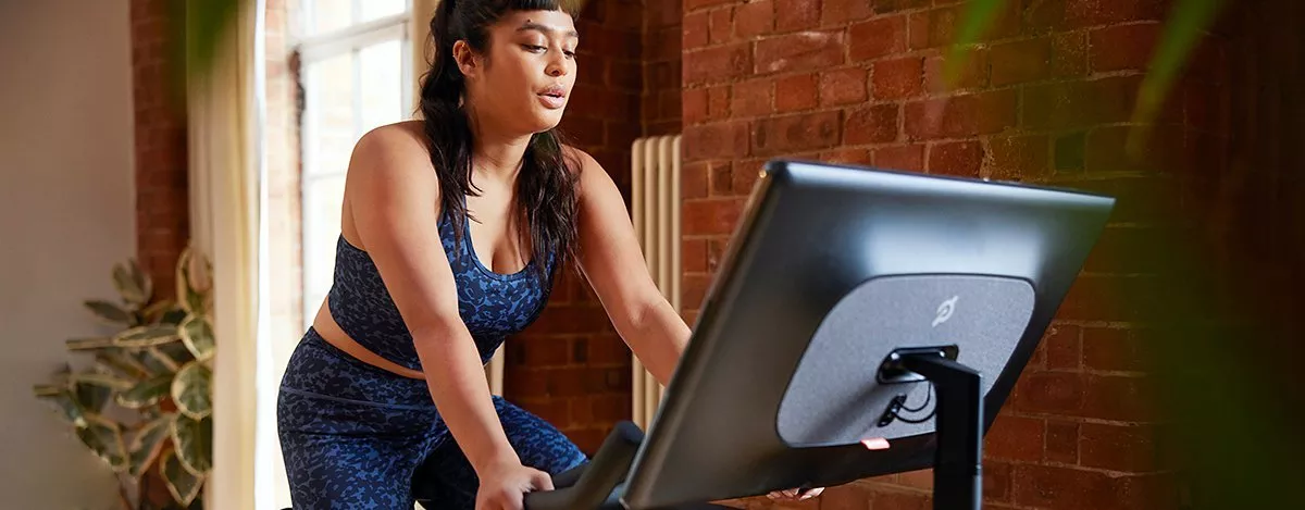 woman on a Peloton exercise bike