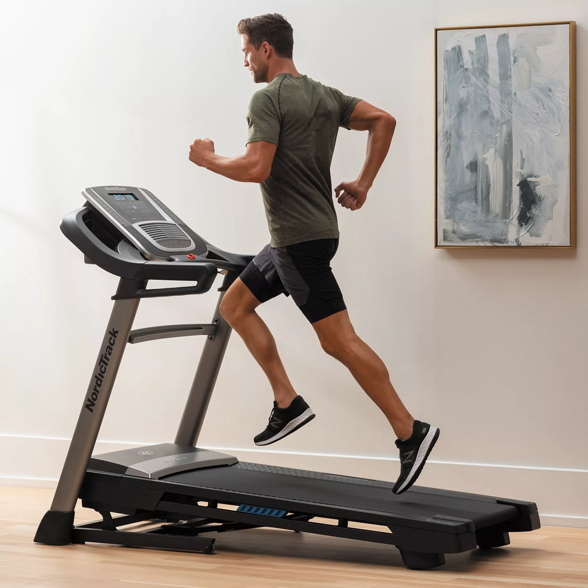 man in sportswear exercising on a running machine