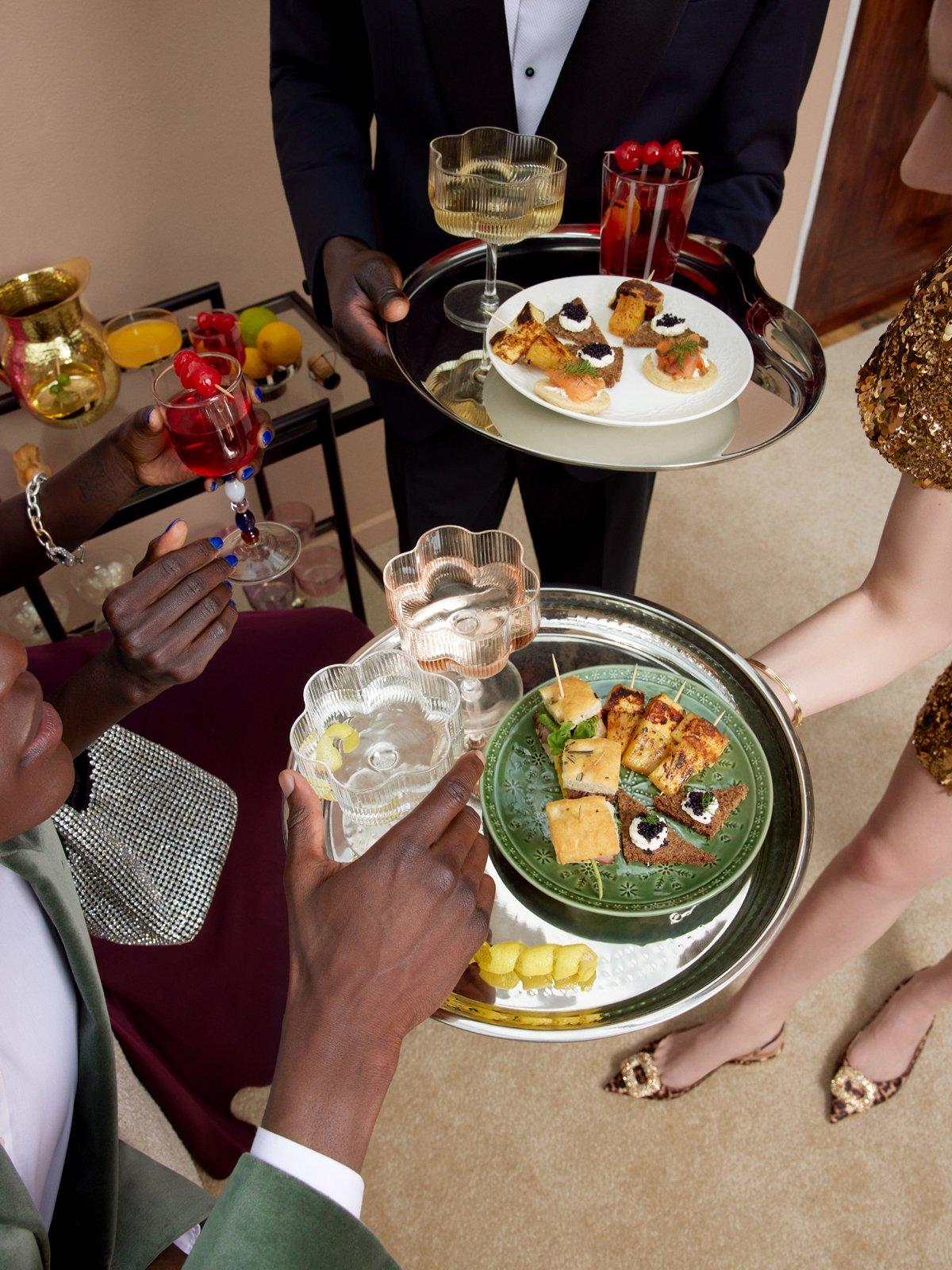 Image of someone holding out some canapes at a party