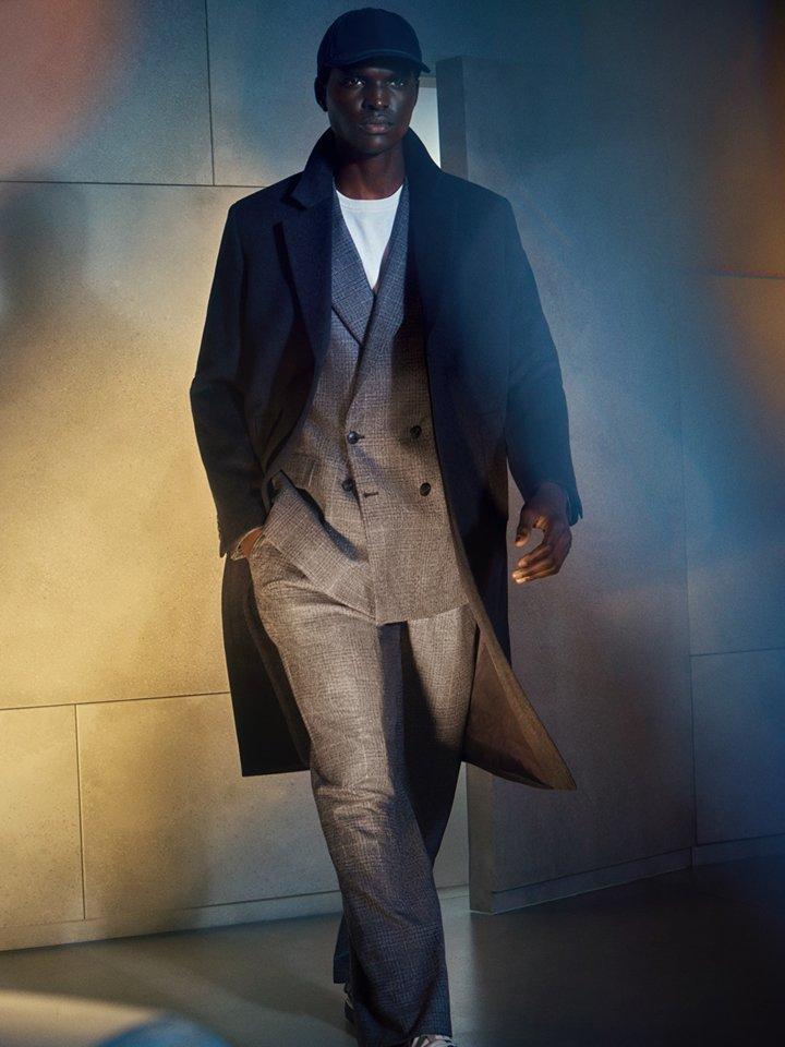 Male model wearing a suit with a round neck tee