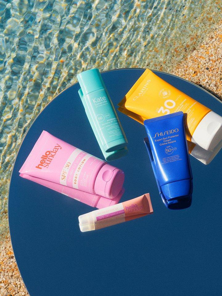 A selection of suncare products on the beach