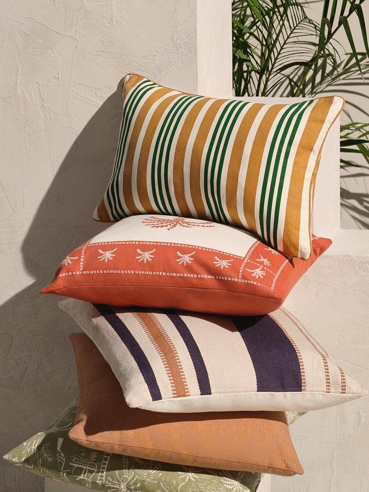 Stack of colourful garden cushions