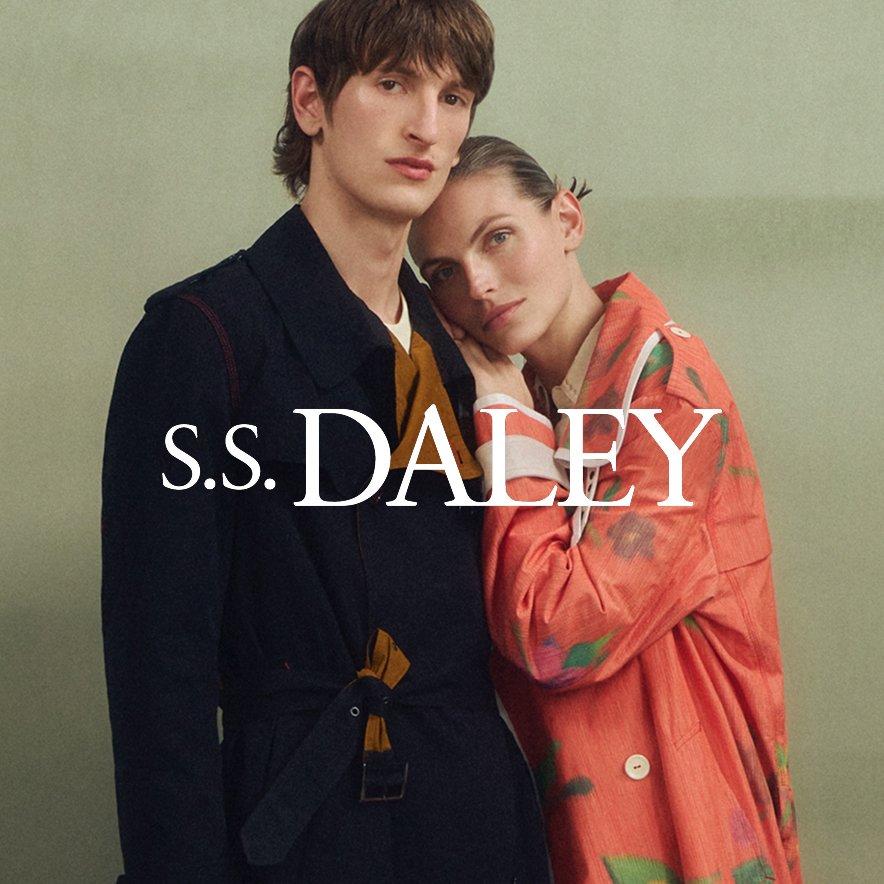 A female and a male model standing and leaning against each other, wearing pieces from the new S.S. Daley collection.