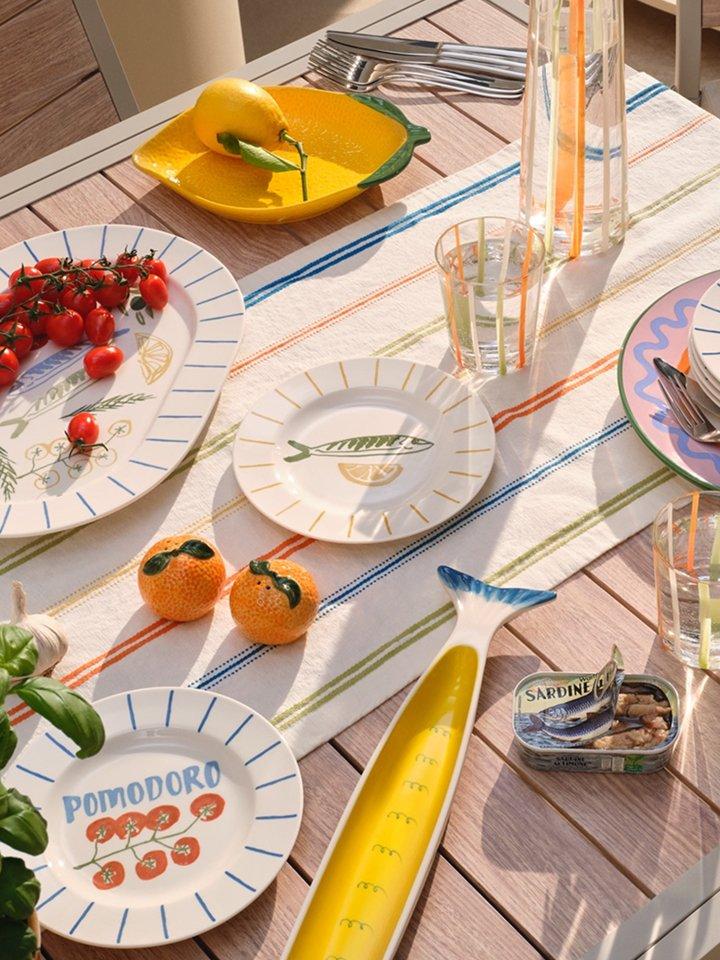A selection of outdoor dining products displayed on a table outside