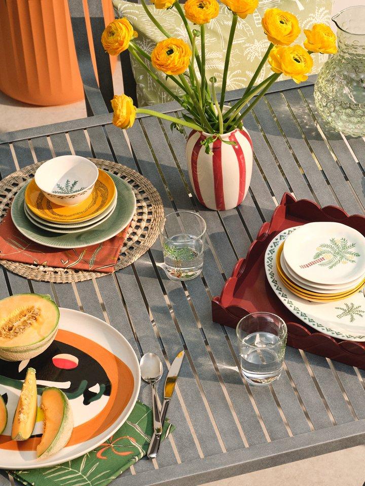 A selection of outdoor dining products displayed on a table outside