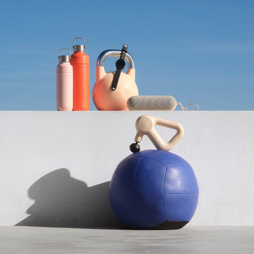 A selection of sports accessories, including water bottles, a portable speaker, and a massager
