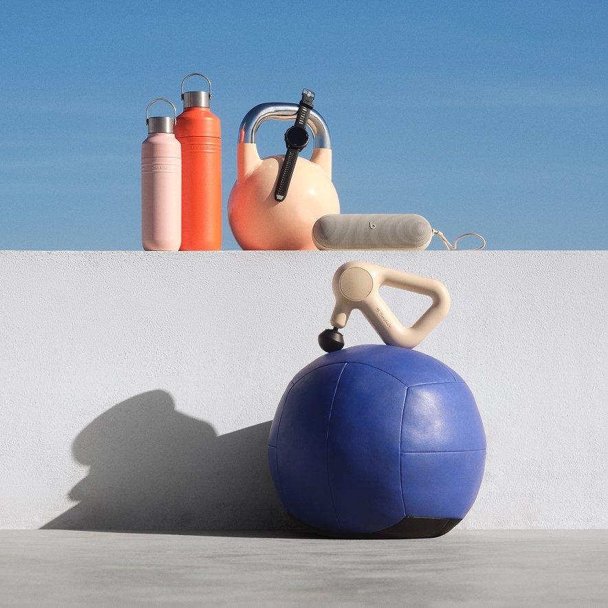A selection of sports accessories, including water bottles, a portable speaker, and a massager