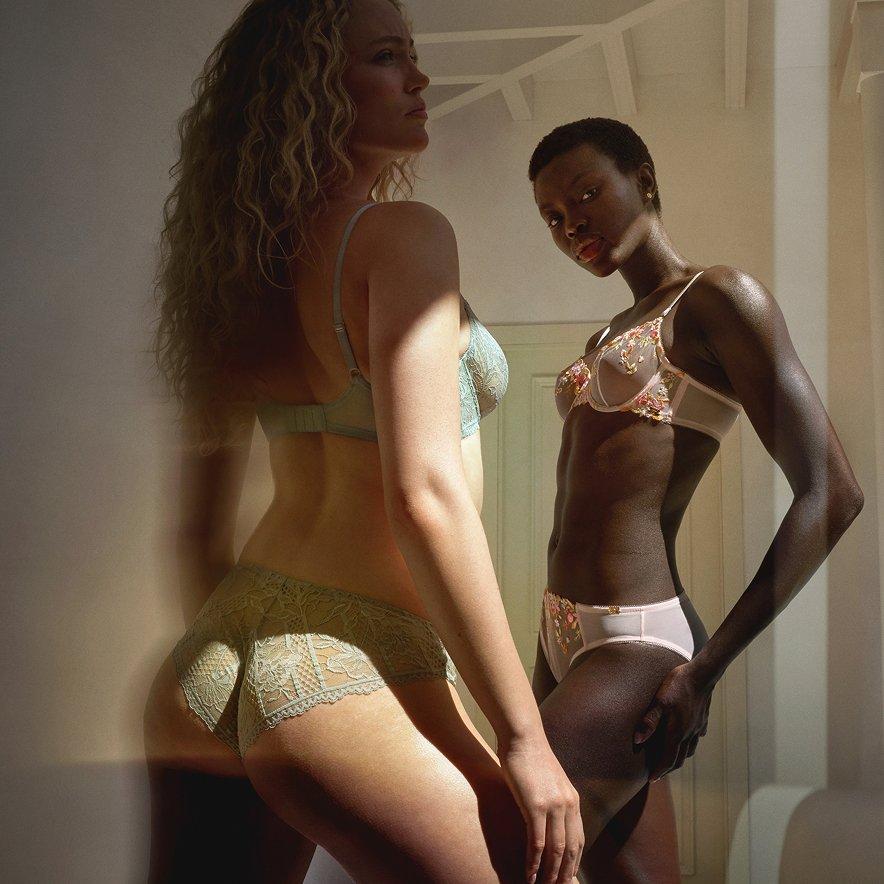 Two female models in lingerie, standing and posing
