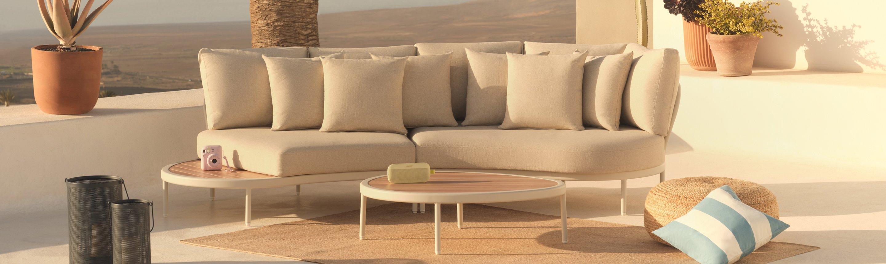 Outdoor furniture and garden accessories displayed outside, next to the sea