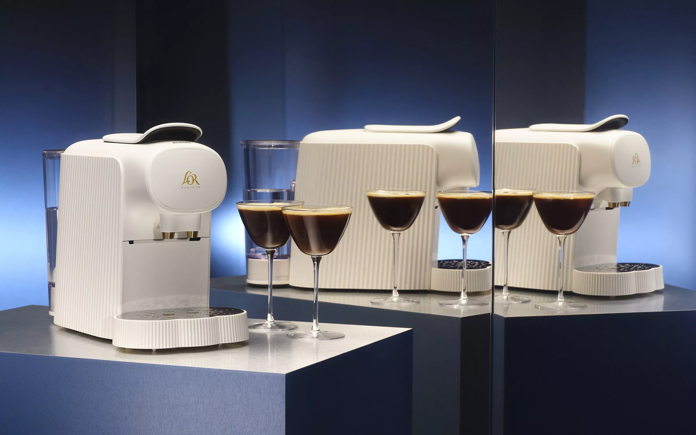 Cream coloured pod coffee machines with espresso martinis next to them 