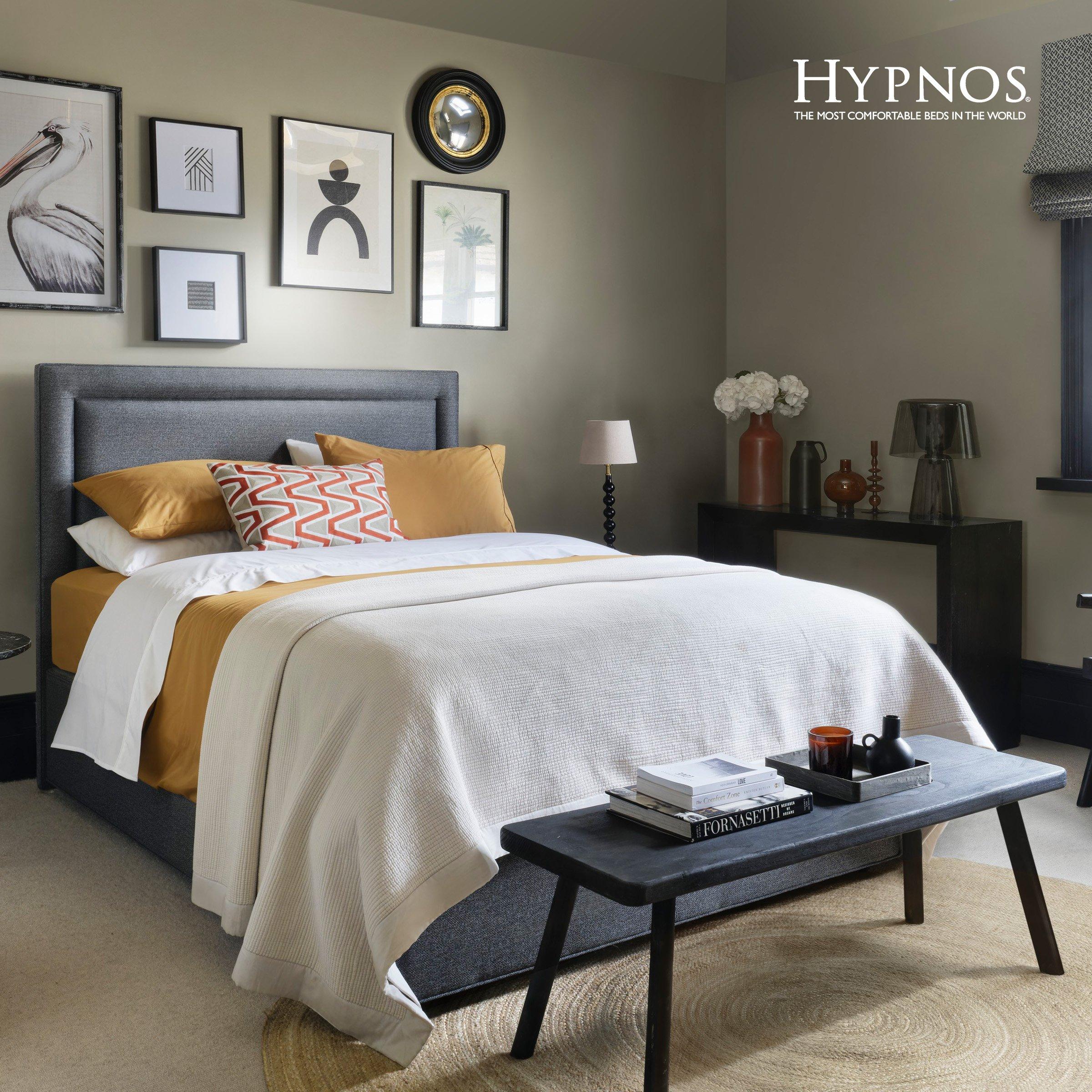 a stylish and modern bedroom with a cozy and well-coordinated interior design