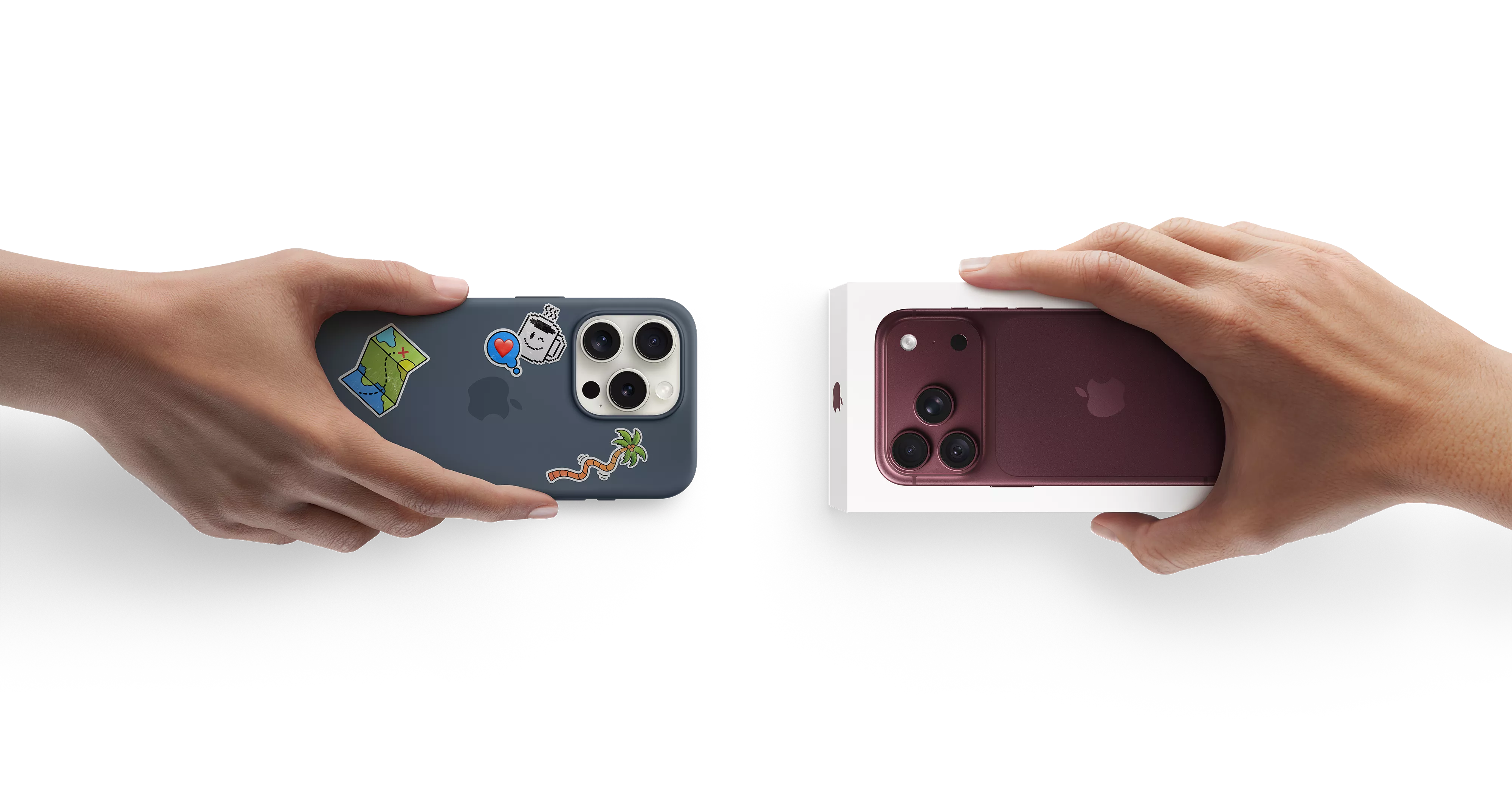 Hands swapping smartphones: stickered iPhone and new iphone in box, isolated on black background