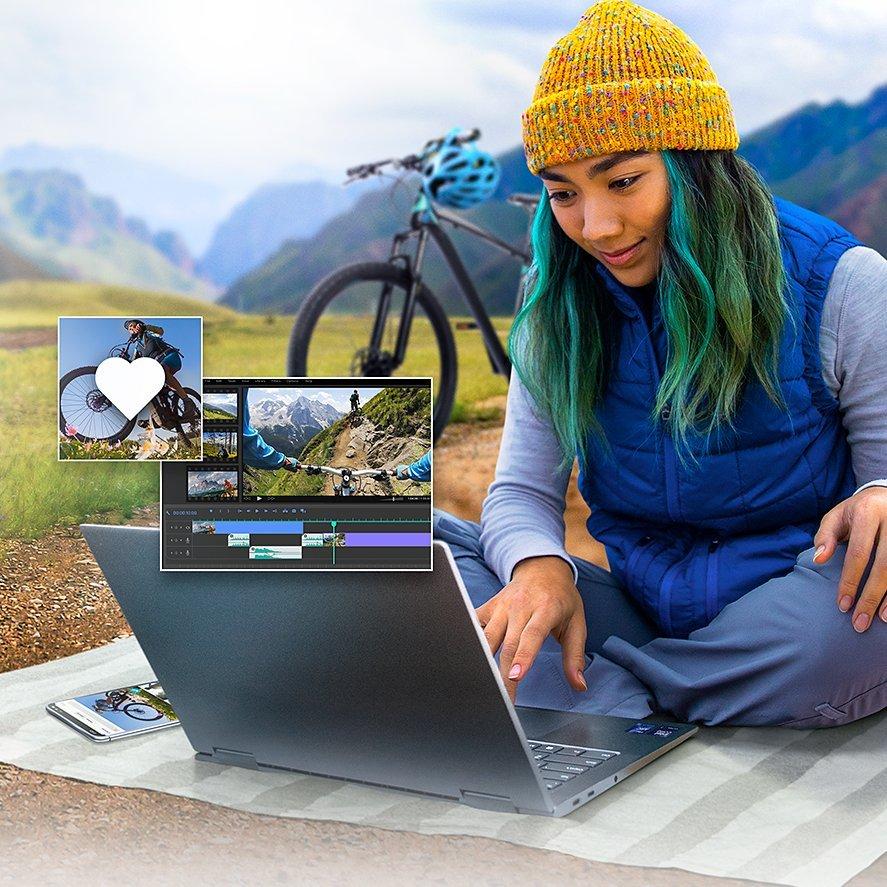 Image of a girl sitting on a picnic rug with an Intel laptop