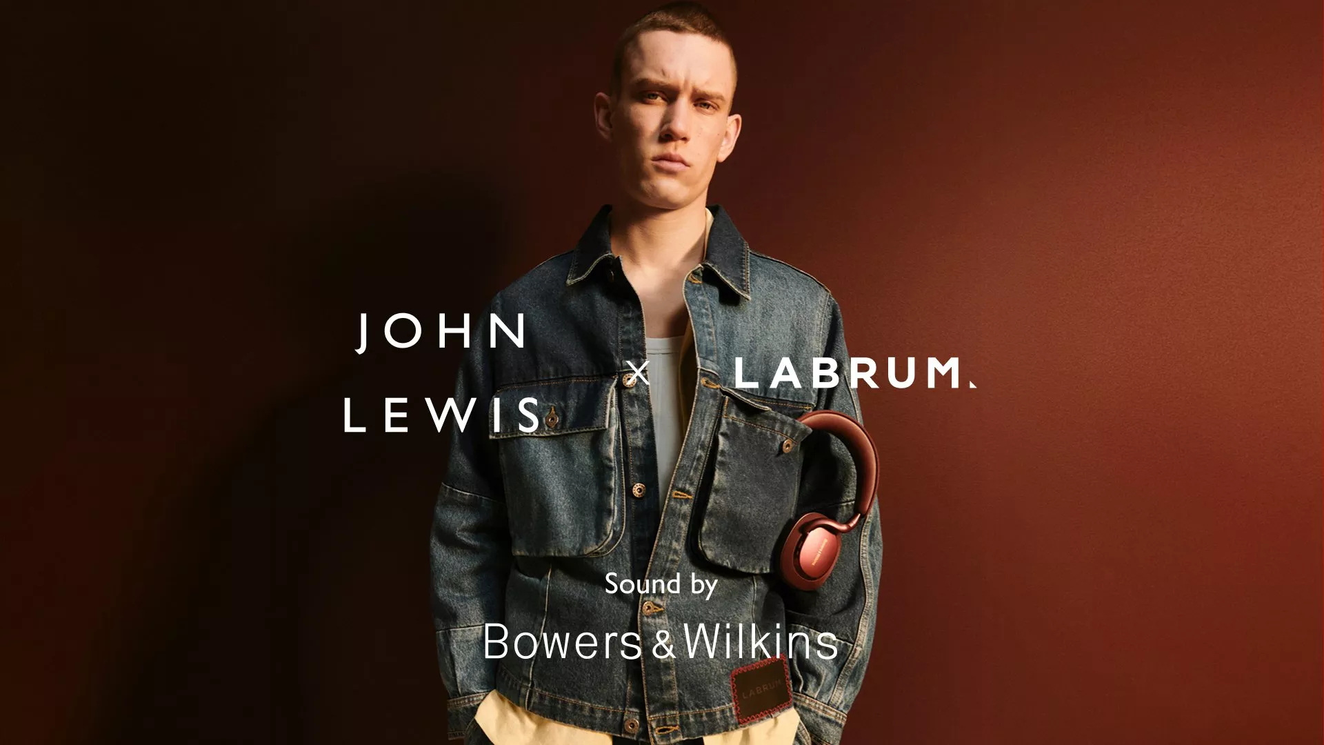 Model in denim jacket with headphones, promoting John Lewis x Labrum collaboration. Bowers & Wilkins sound.