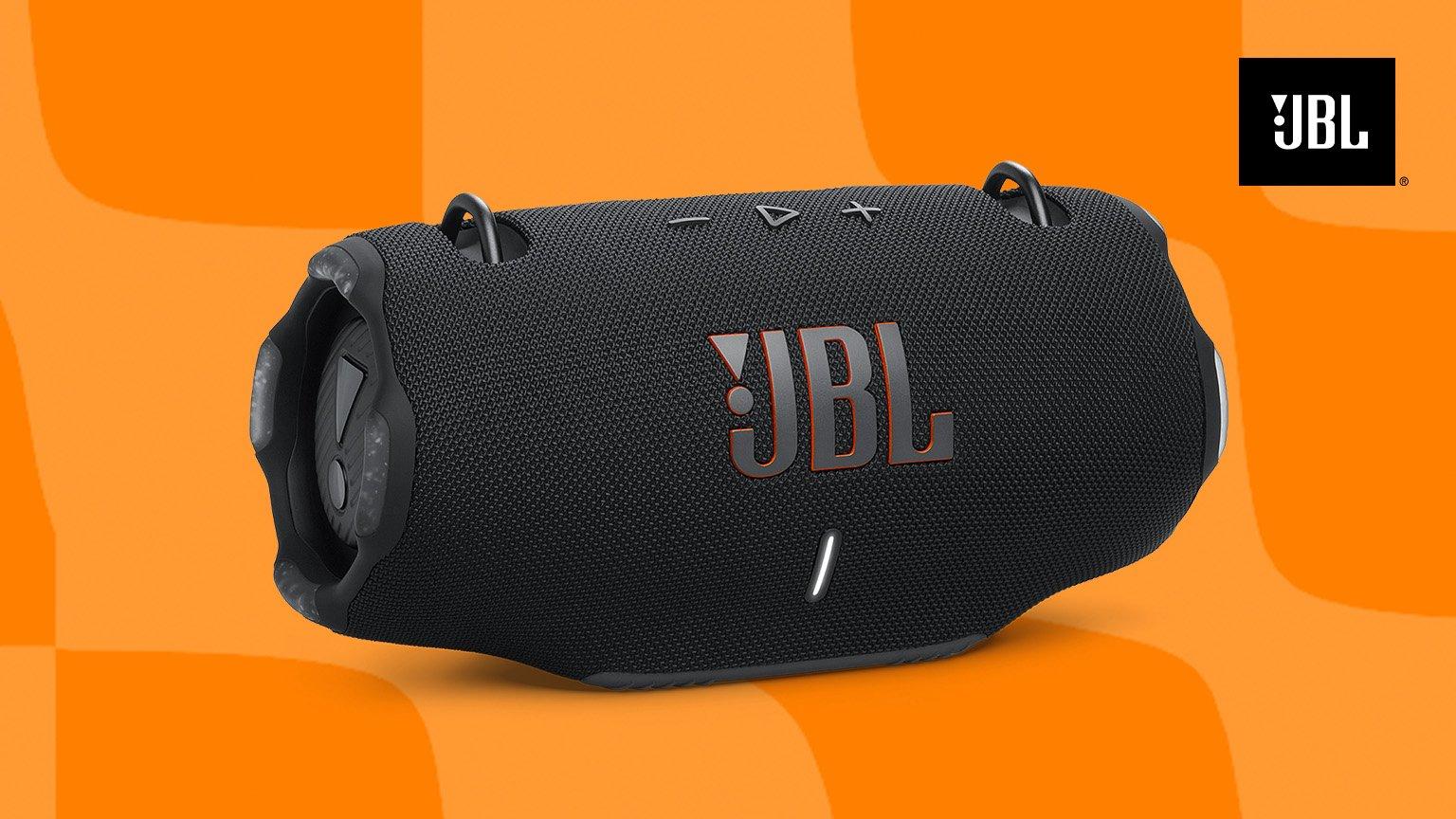 A black JBL portable speaker on an orange background.