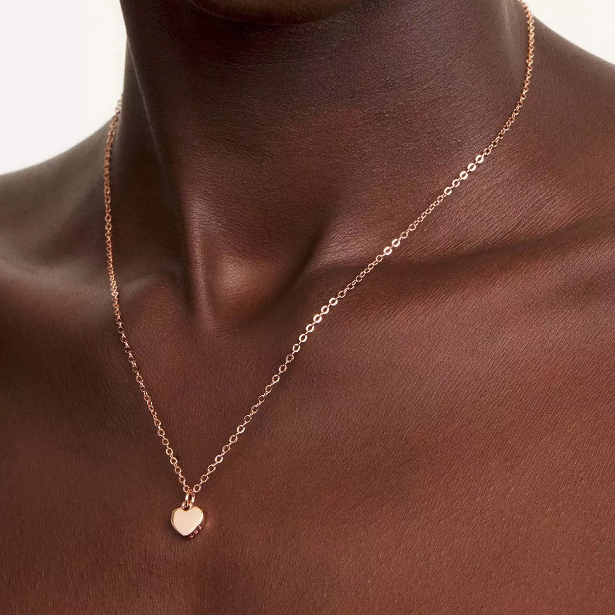 woman wearing gold chain pendant necklace