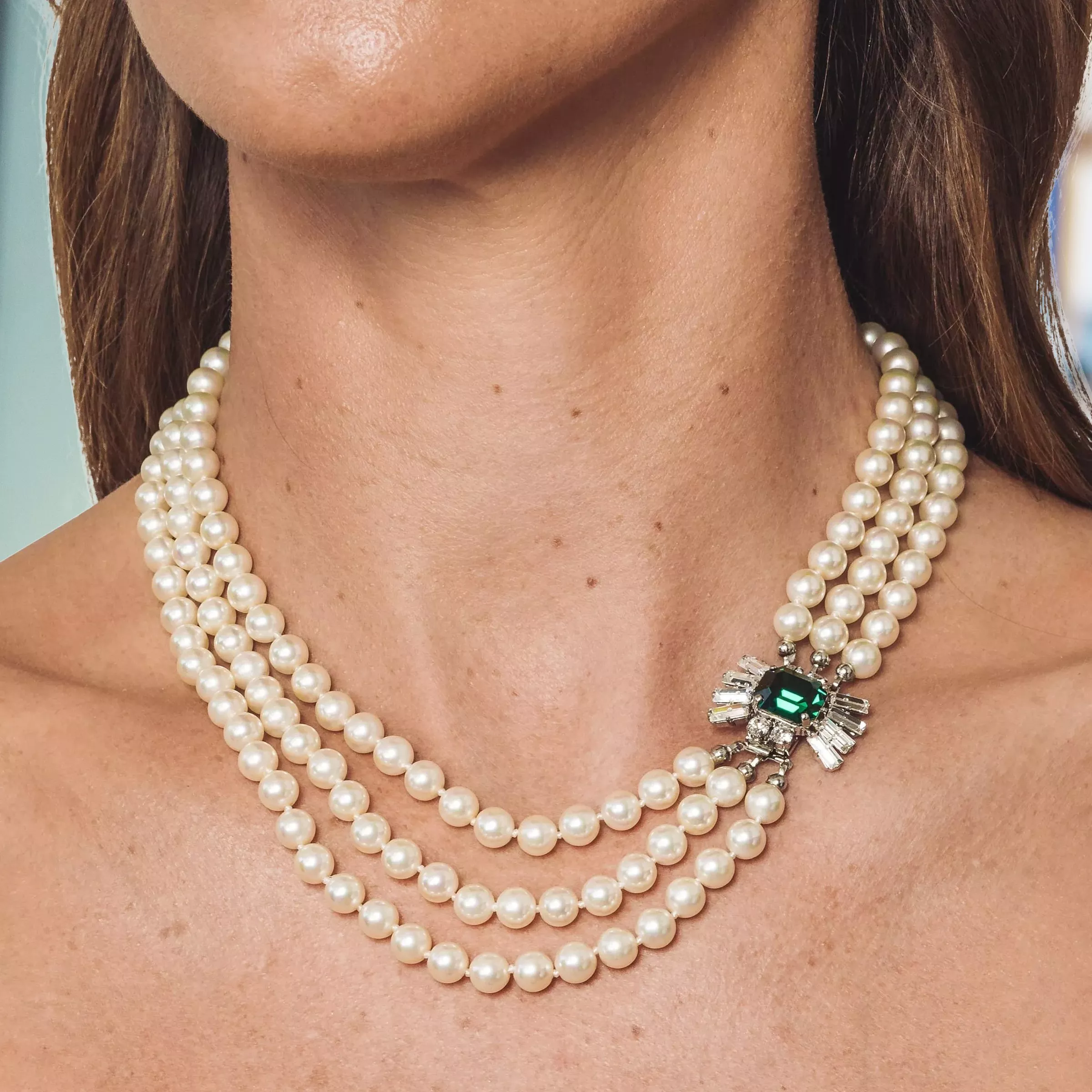 woman wearing pearl pendant necklace