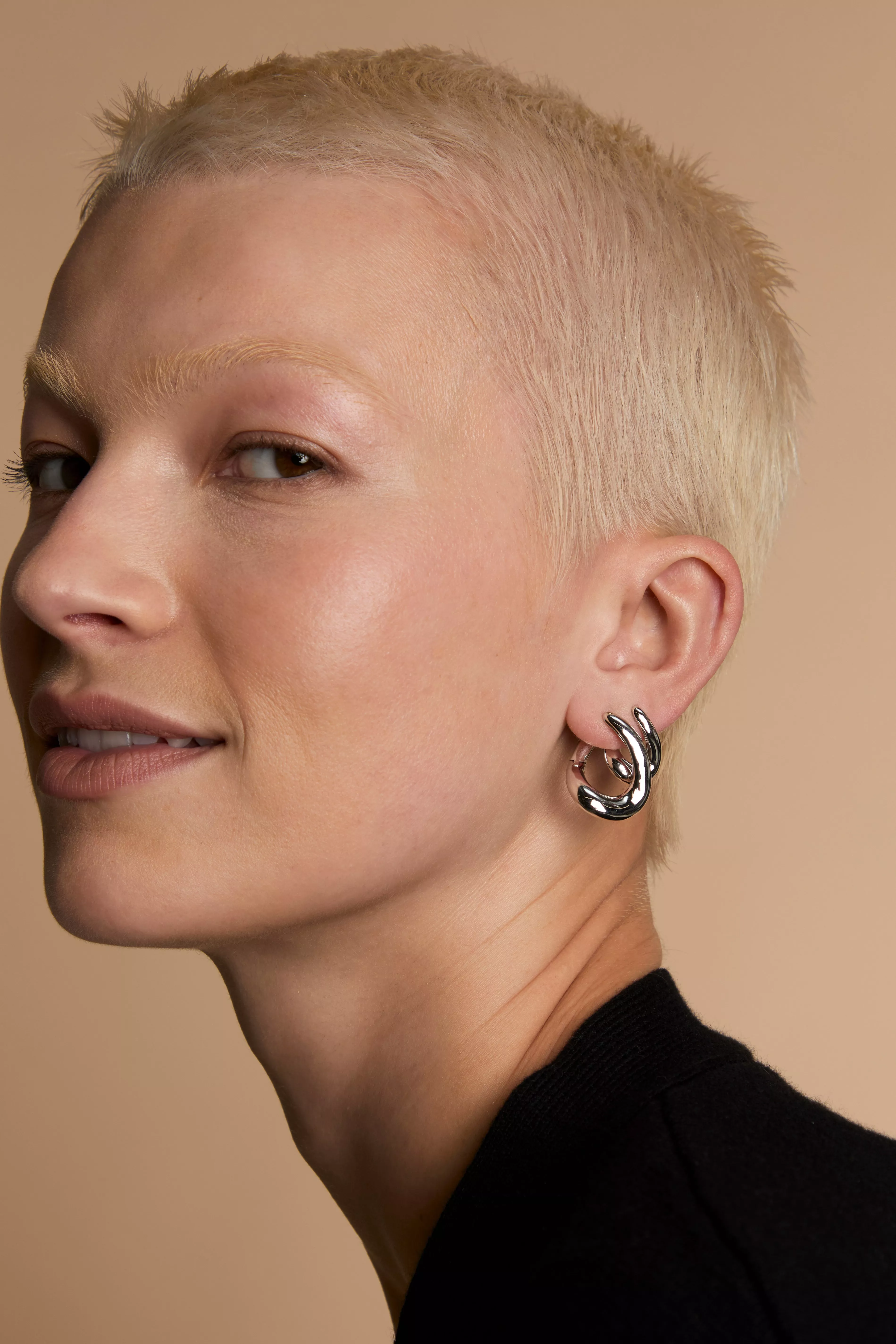 Person wearing a silver hoops