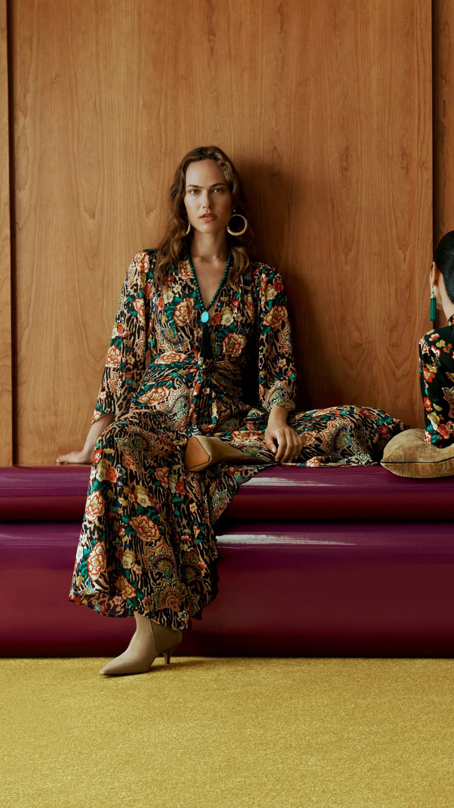 two women on a red seat. 