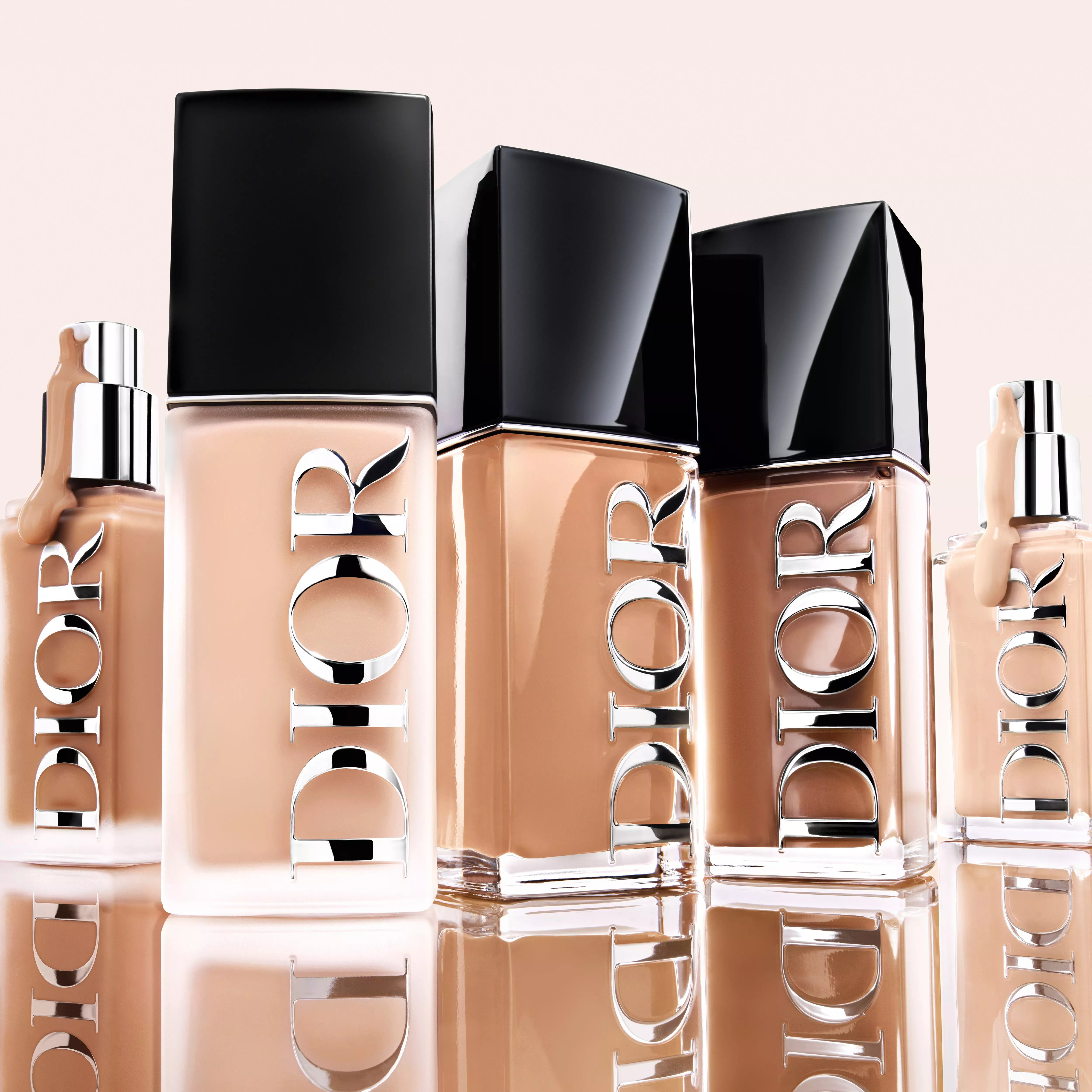 Gold compacts with intricately embossed floral makeup powders on a soft, light-reflecting surface.