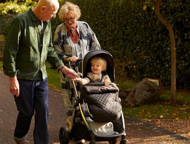 An infant enjoying a ride in a pram