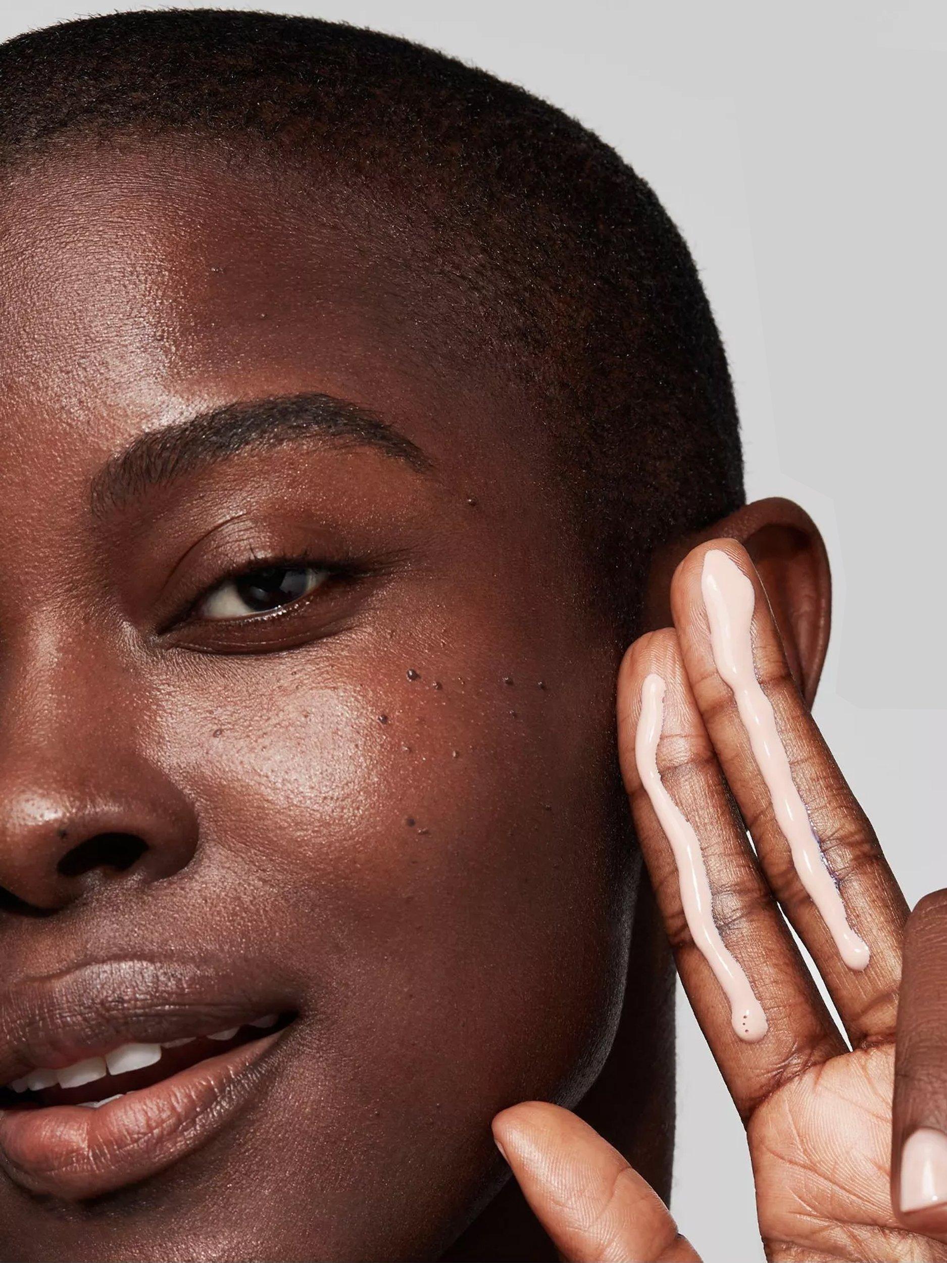 Image of a model with cream on her fingers