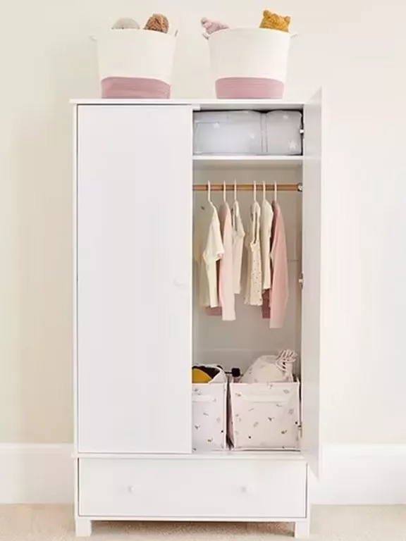 white wardrobe with clothing on rail