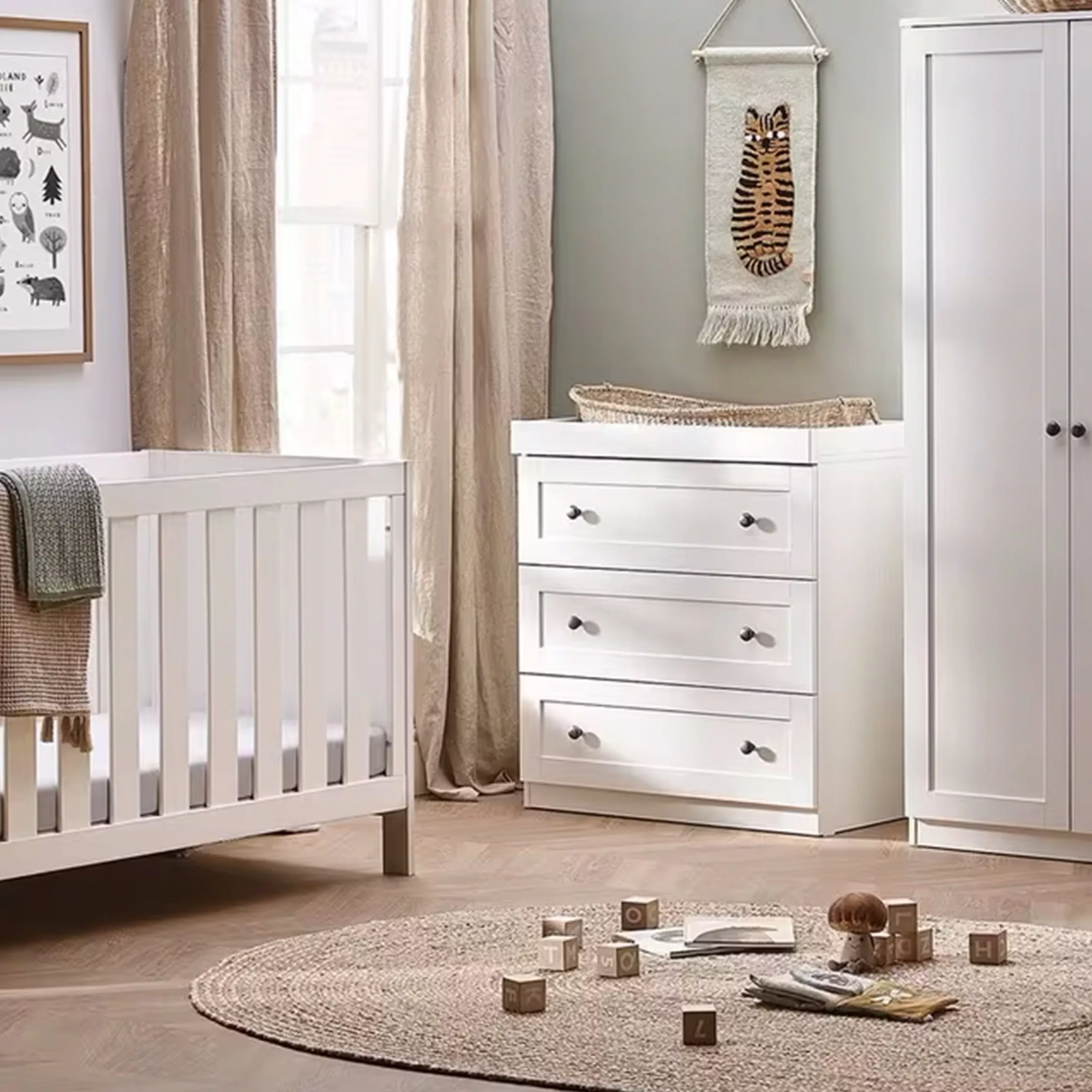 cot and chest of drawers in baby nursery