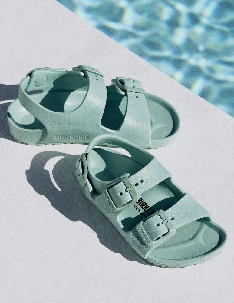Kids' Rio Sandals, Sage Green Birkenstock next to poolside