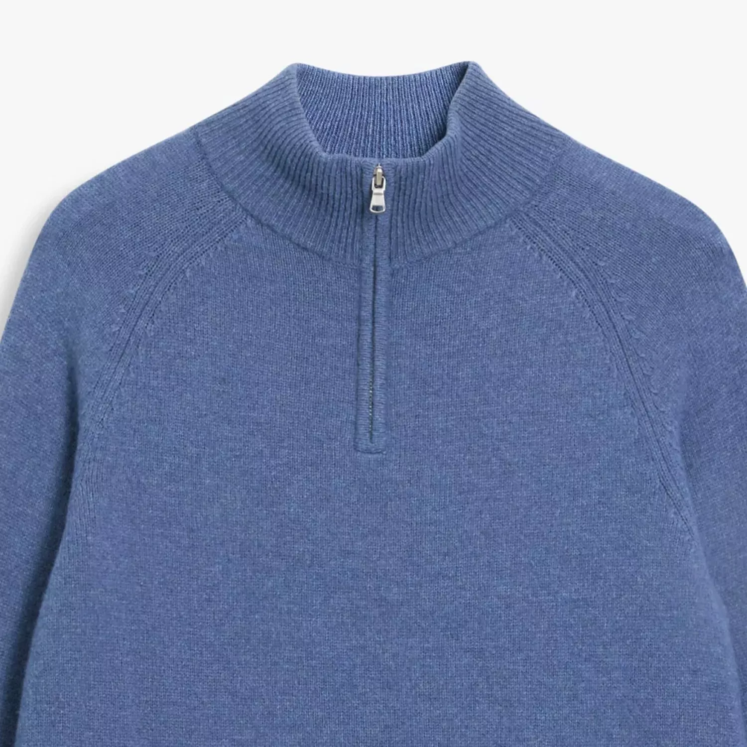 Blue knit half-zip jumper with ribbed funnel neck and raglan sleeves, close-up product photo on white background