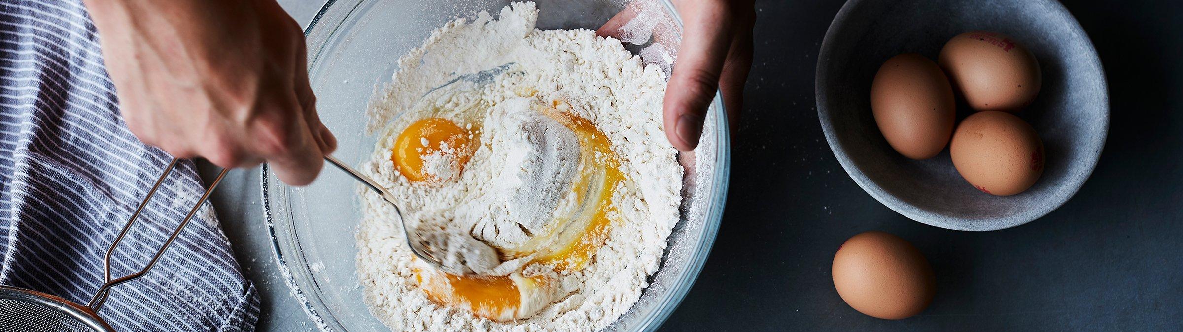 whisking eggs in a glass bowl
