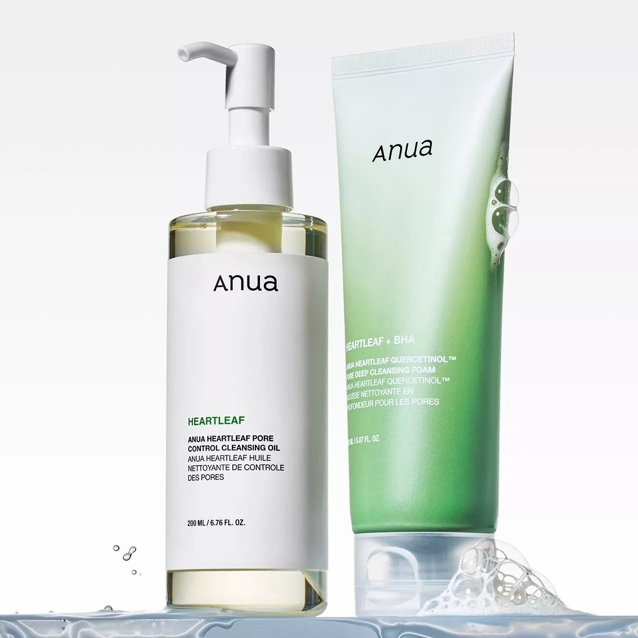 Anua Heartleaf cleansing oil pump bottle and Heartleaf + BHA deep cleansing foam tube on a clean white background