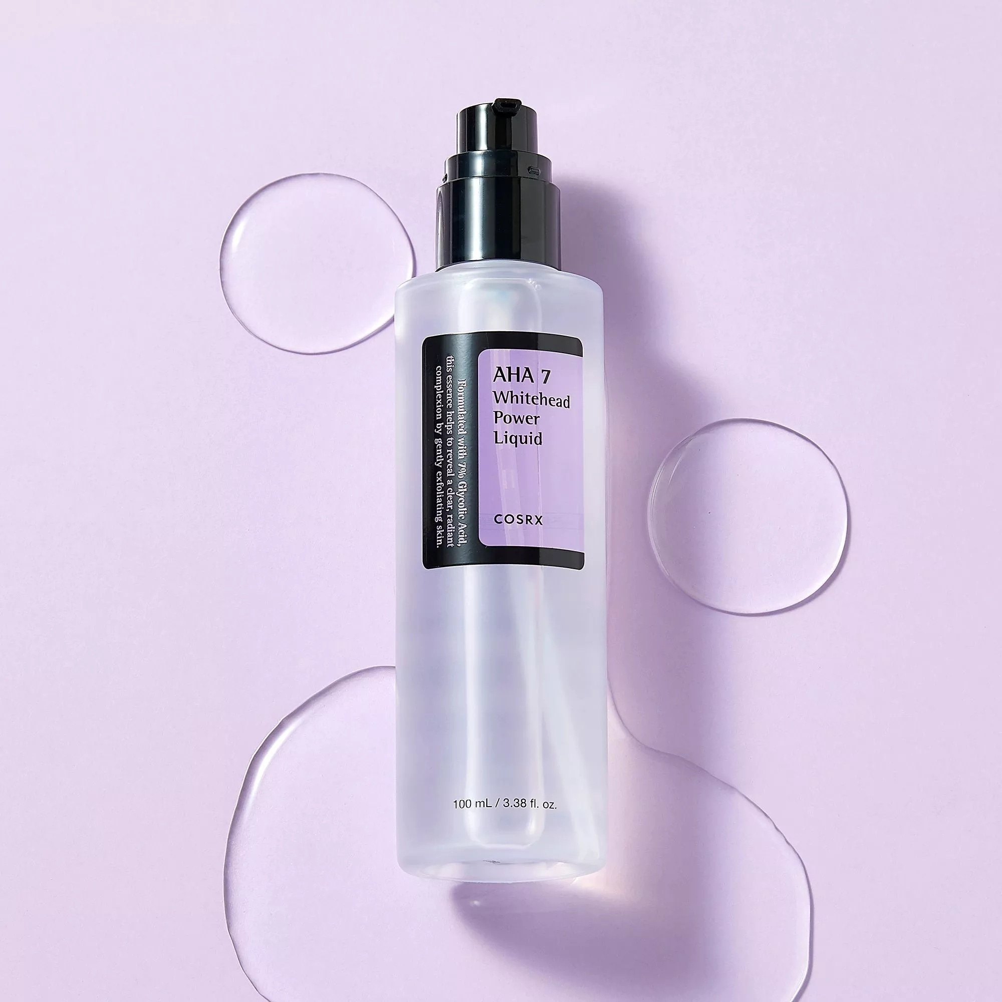 COSRX AHA 7 Whitehead Power Liquid exfoliating toner bottle on lilac background with gel droplets