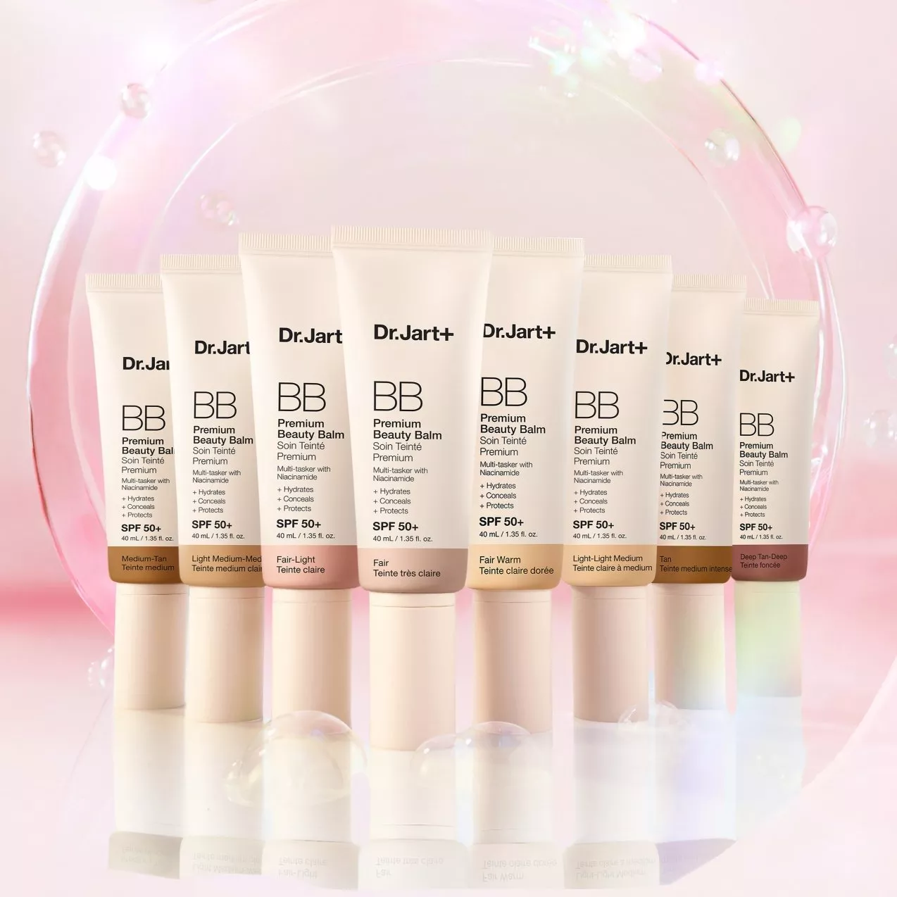 Dr.Jart+ BB Premium Beauty Balm SPF 50+ tubes in multiple shades on a pink background with bubbles