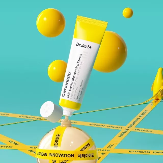 Dr.Jart+ Ceramidin skin barrier moisturising cream tube with yellow spheres on turquoise background, K-beauty theme
