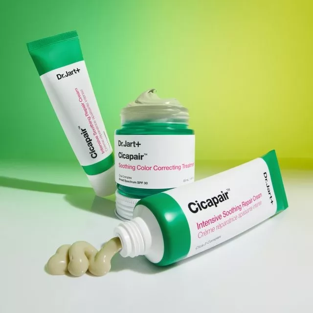 Dr.Jart+ Cicapair skincare set with colour correcting treatment, repair cream tube and jar on green background