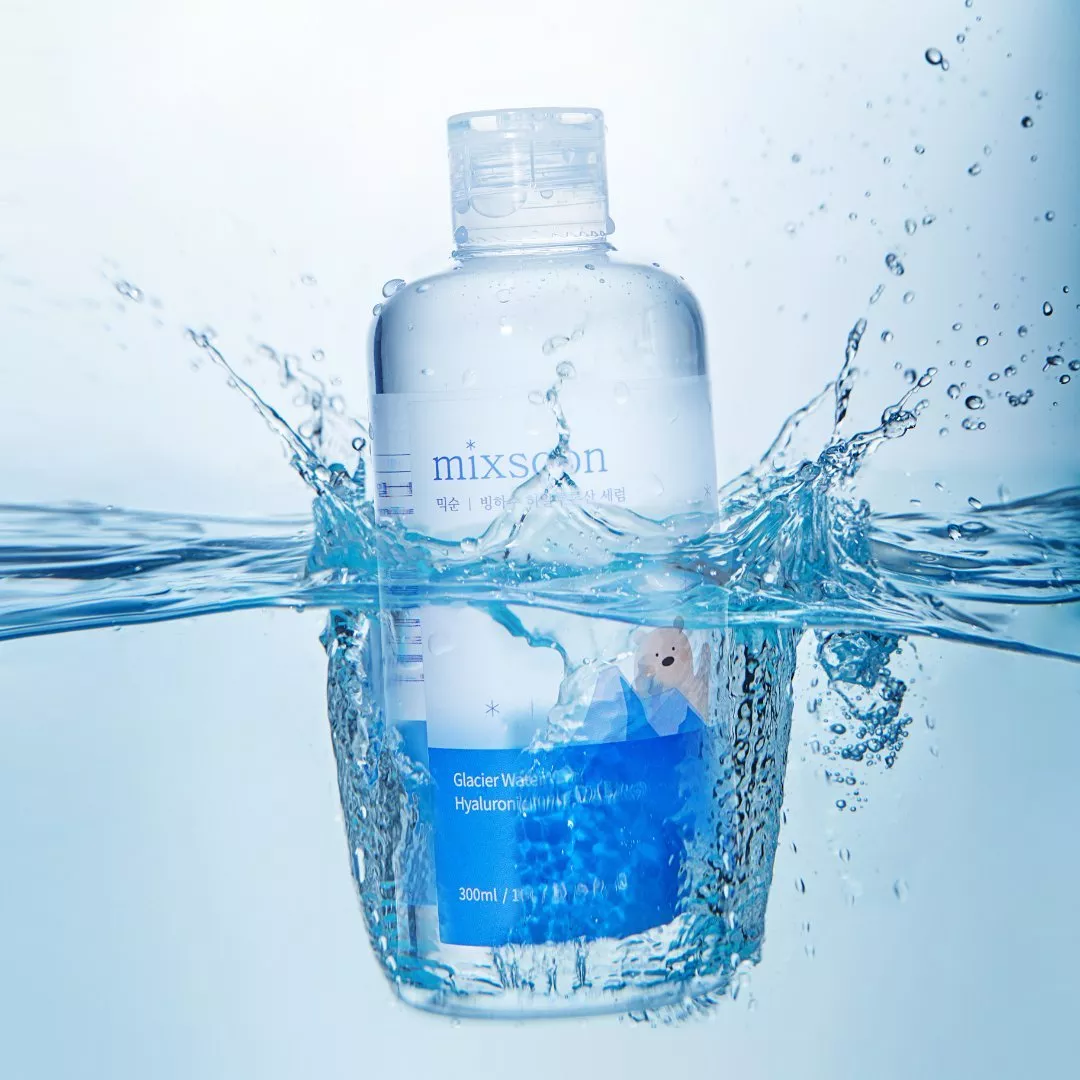 Mixsoon Glacier Water Hyaluronic Acid serum bottle splashing in water, hydrating skincare product photo