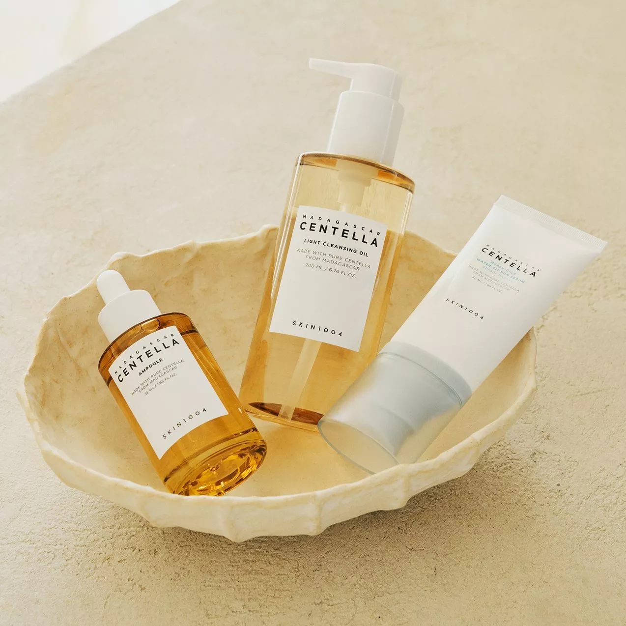 SKIN1004 Madagascar Centella skincare set with ampoule, cleansing oil and foam cleanser in a ceramic dish