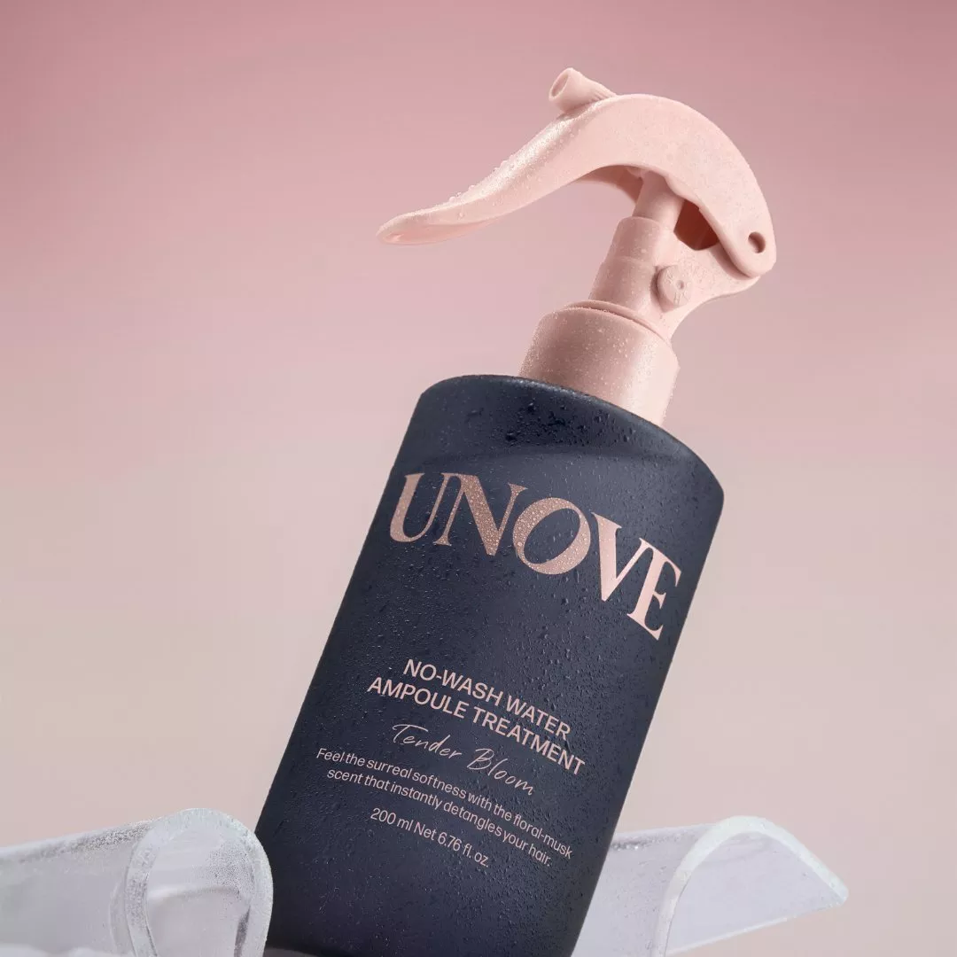 UNOVE no-wash hair ampoule treatment spray bottle with pink pump, close-up product shot on pastel background