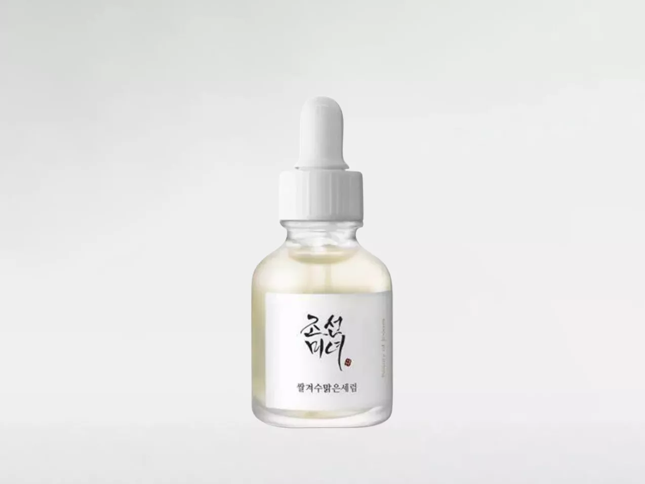 Glass dropper bottle of Korean skincare serum on white background, minimalist product photography for e-commerce.