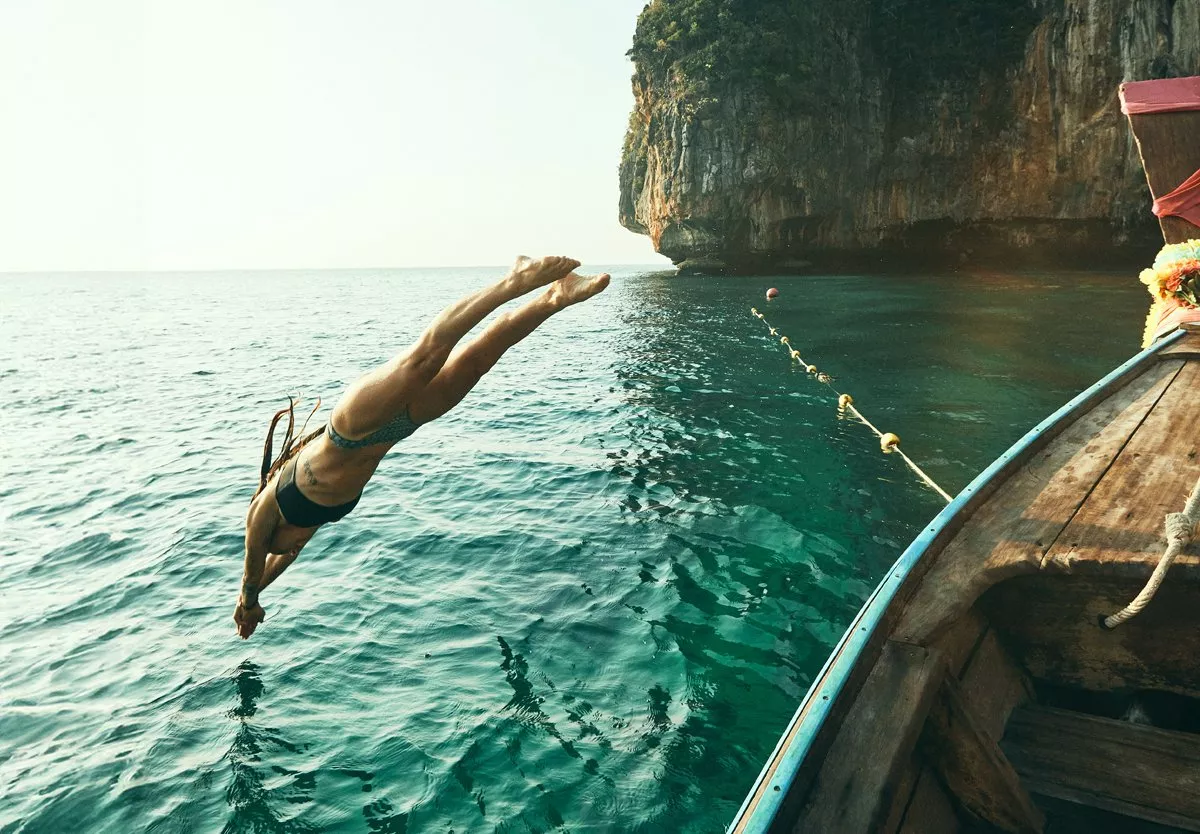 Person diving off a boat into the sea