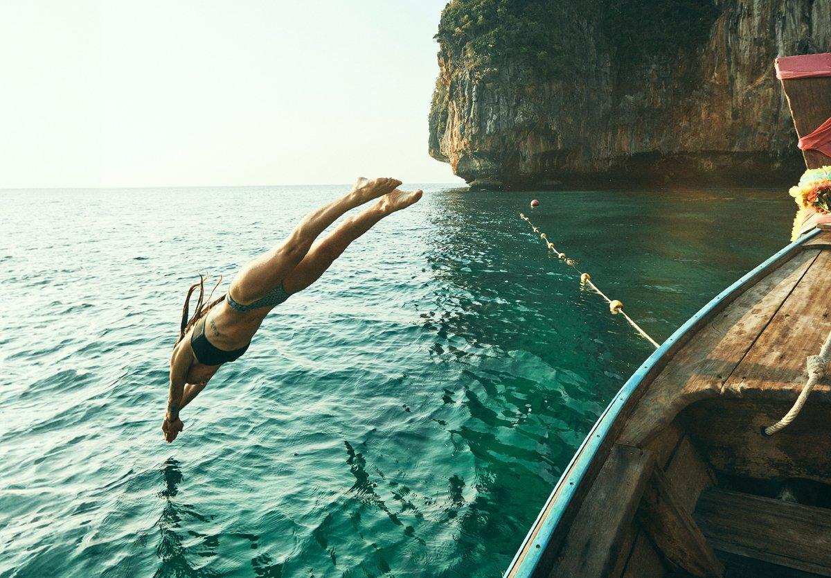 kuoni image of a women diving off a boat