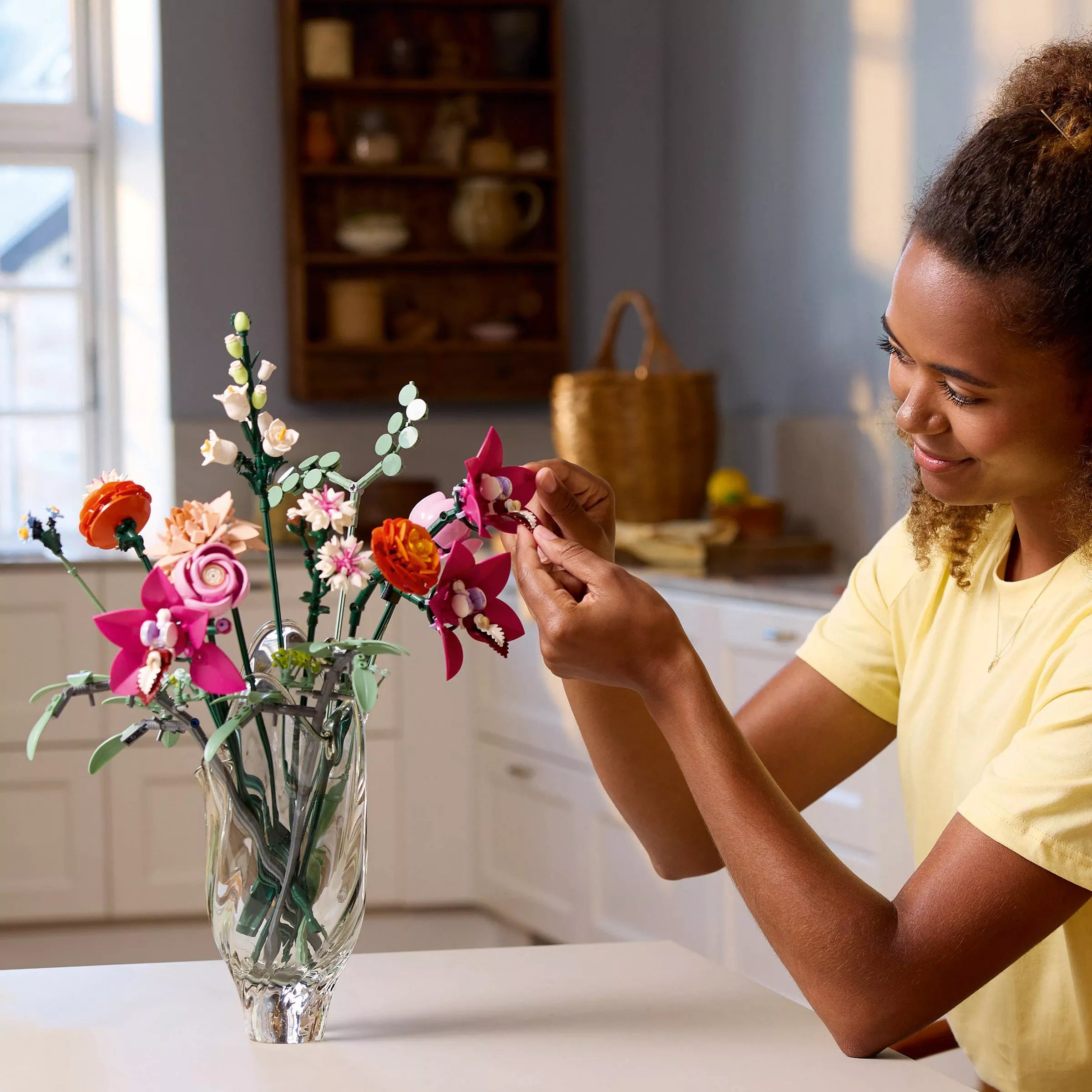 women finishing building a LEGO flower bouquet