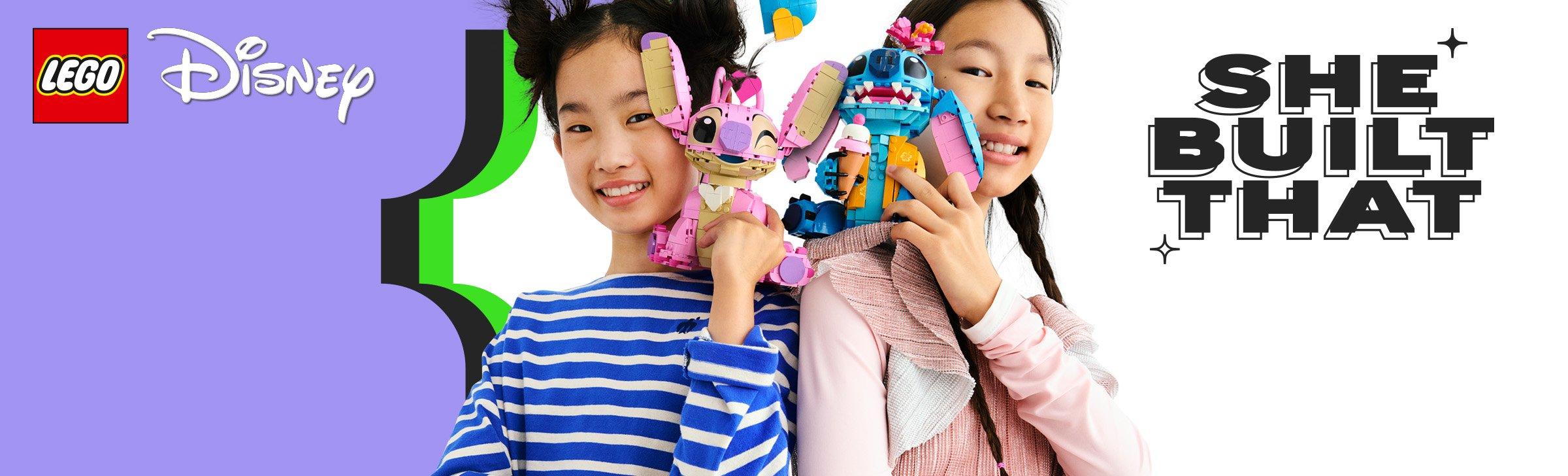 Two smiling girls proudly display LEGO Disney Stitch creations and celebrating their achievement.
