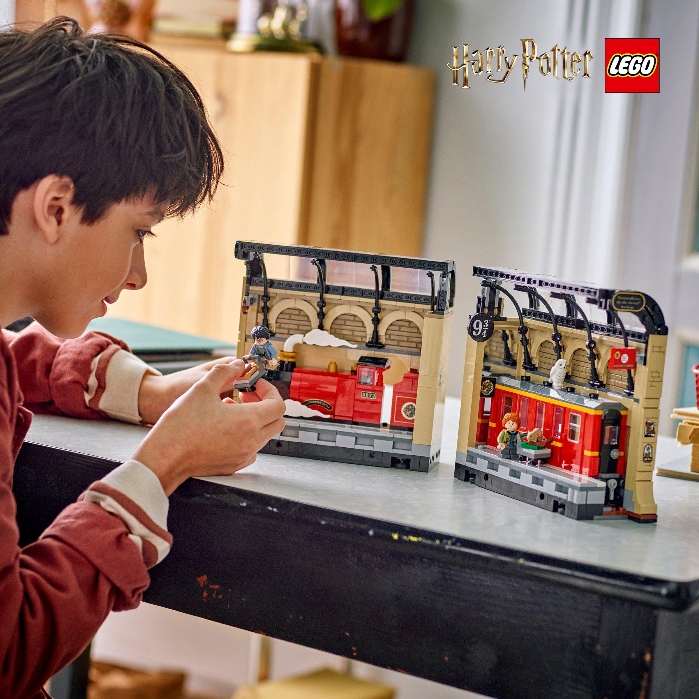 Boy building the harrypotter lego edition on the table